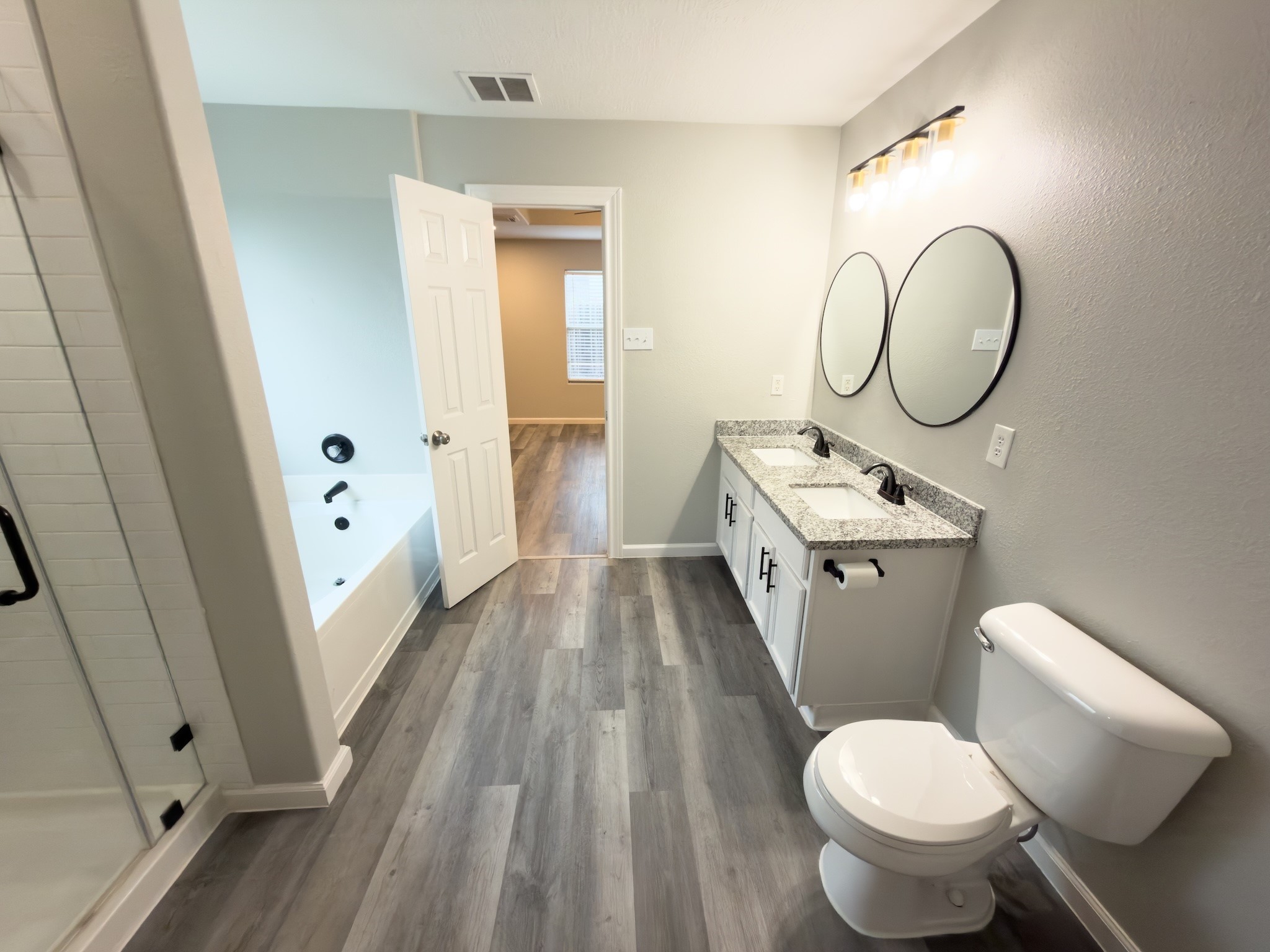 6626 Springfield Garden Lane Spring, TX 77379 - Photo 15 of 23 a bathroom with a toilet sink and a mirror