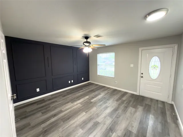 wooden floor in an empty room with a window