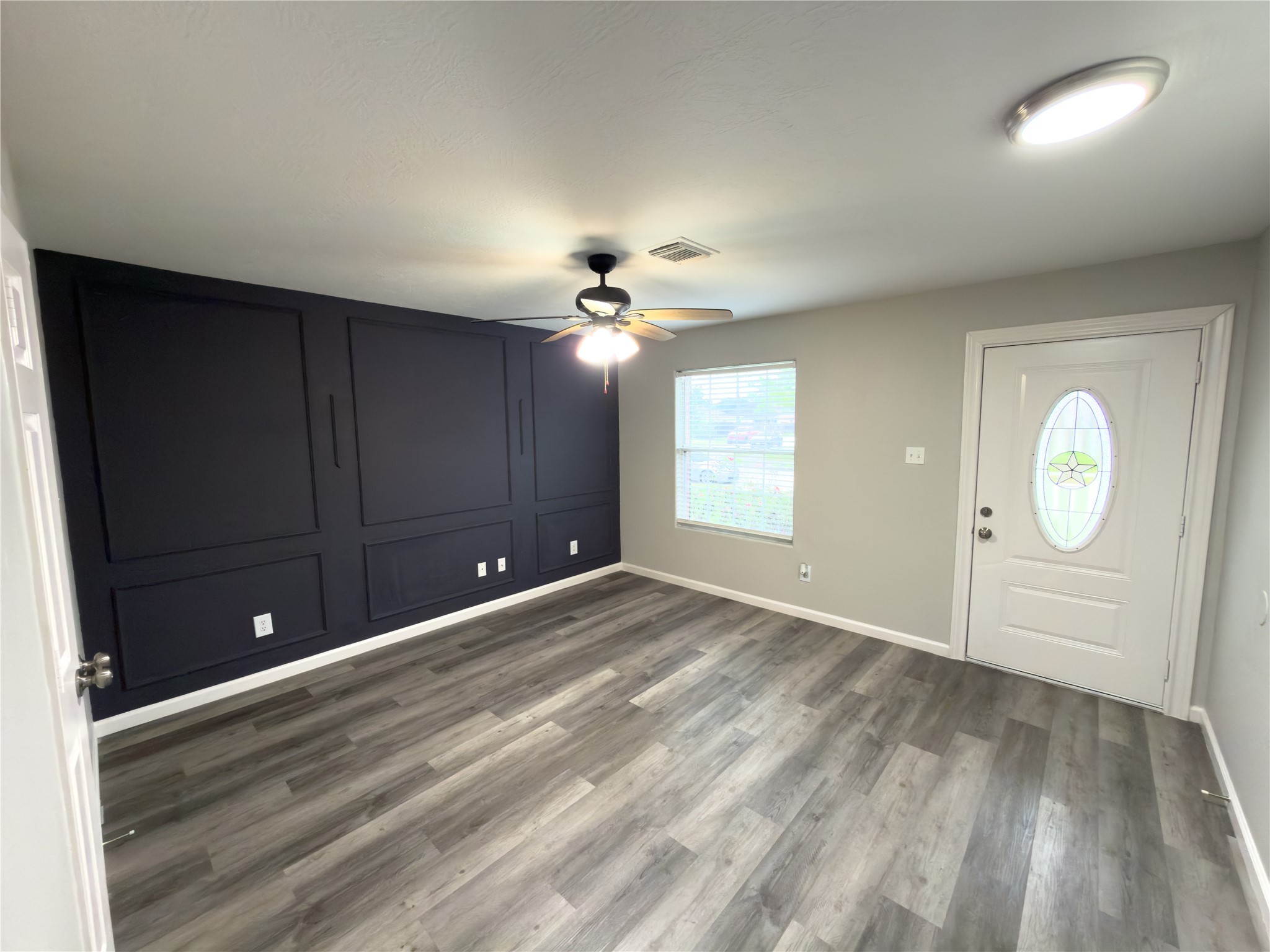 6626 Springfield Garden Lane Spring, TX 77379 - Photo 3 of 23 wooden floor in an empty room with a window