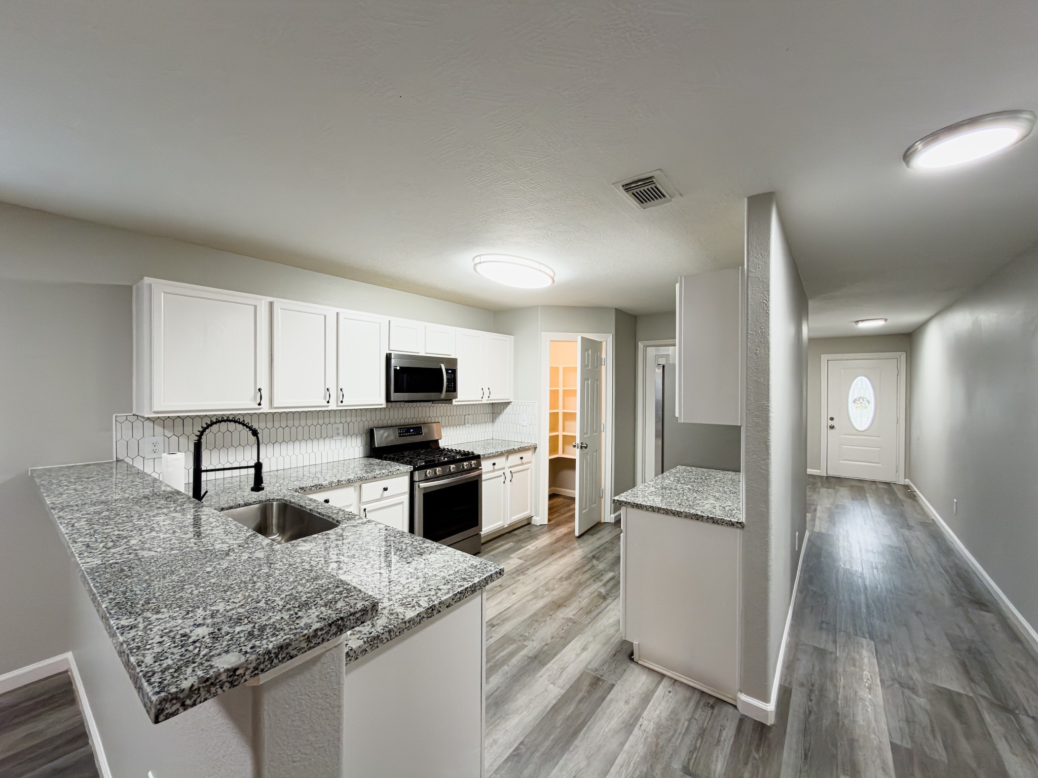 6626 Springfield Garden Lane Spring, TX 77379 - Photo 4 of 23 a kitchen with stainless steel appliances granite countertop a sink stove and cabinets