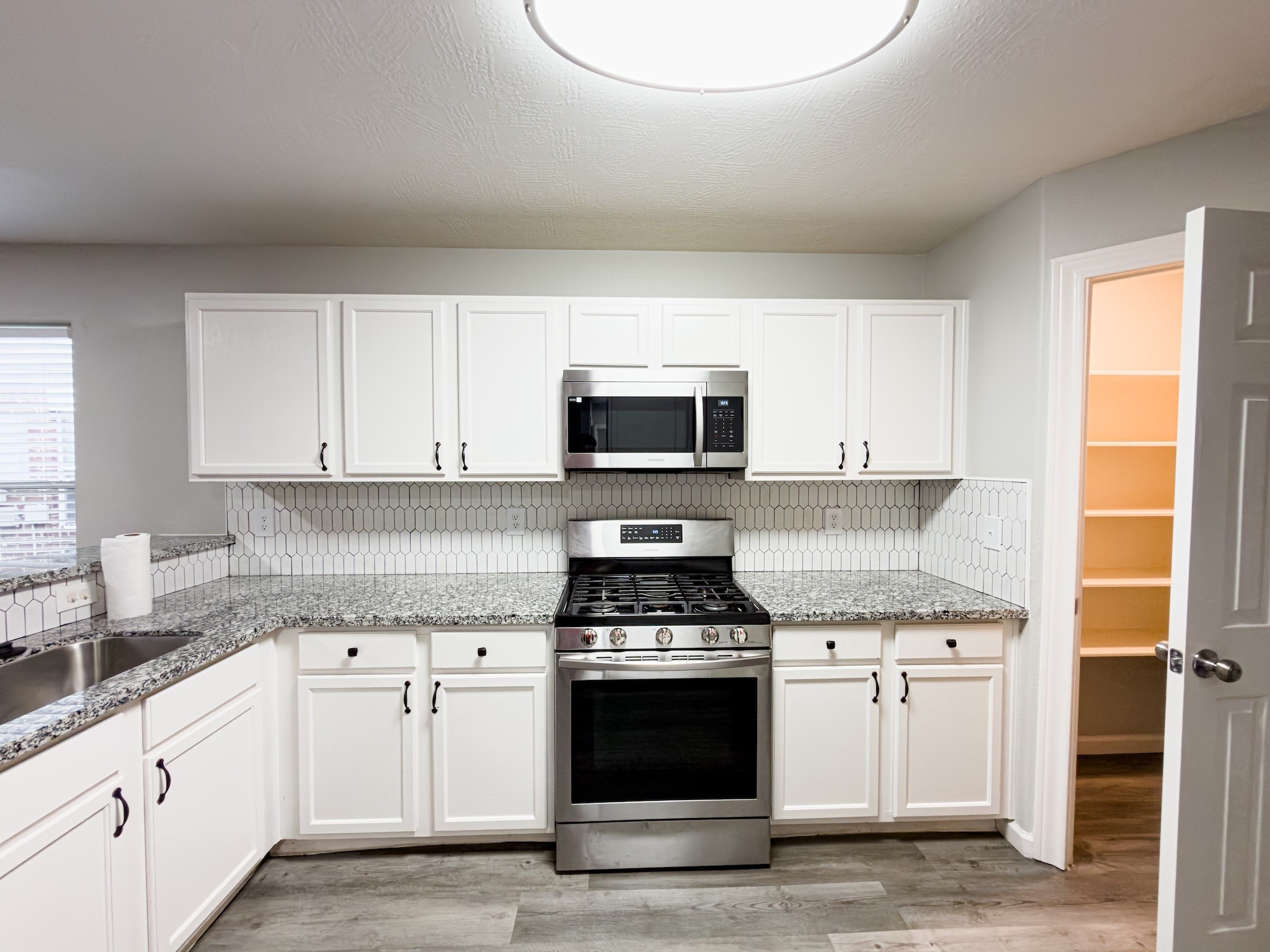 6626 Springfield Garden Lane Spring, TX 77379 - Photo 5 of 23 a kitchen with granite countertop a stove and a sink