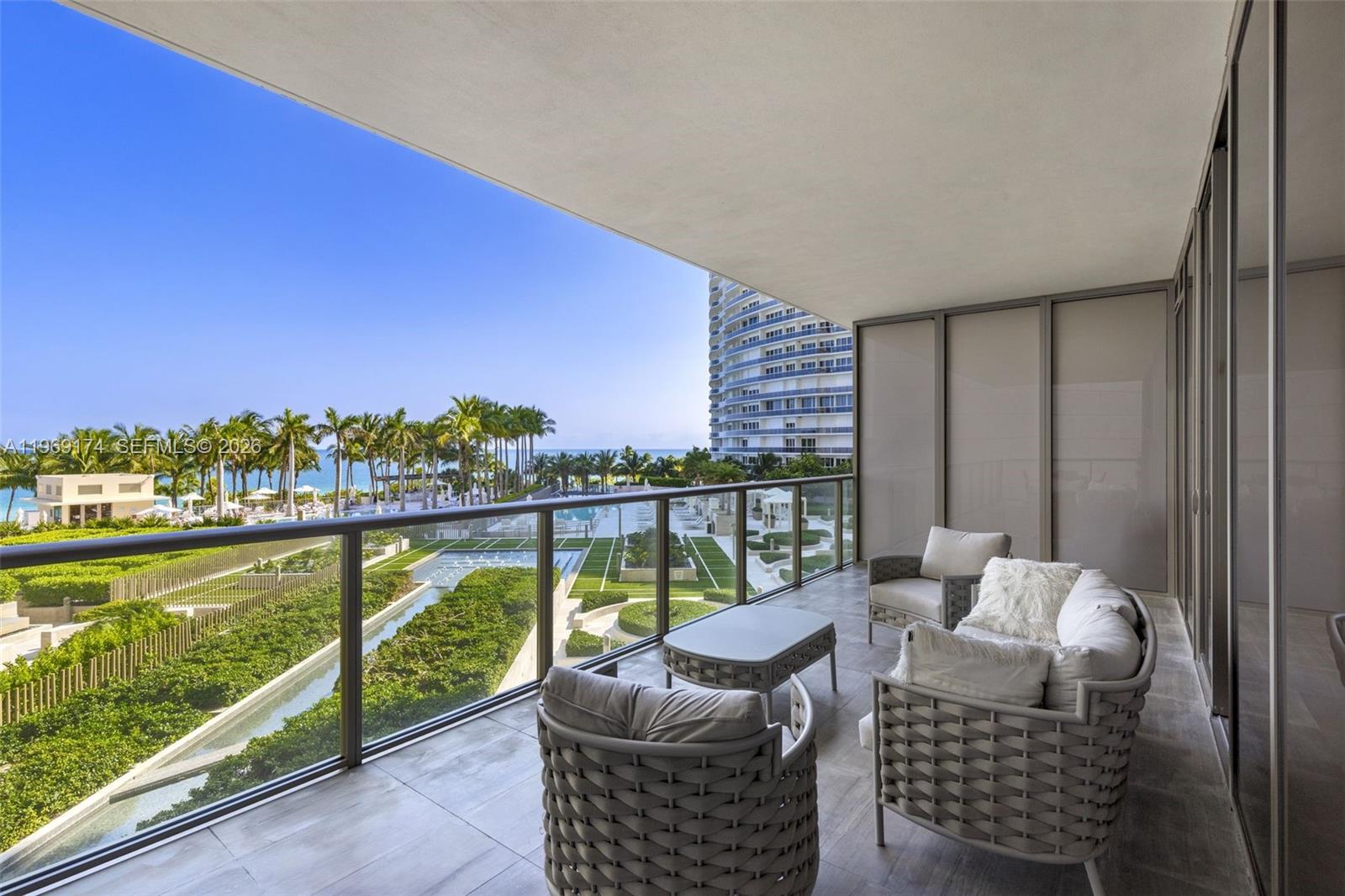 9701 Collins Avenue, Unit 404S Bal Harbour, FL 33154 - Photo 1 of 40 a balcony with furniture