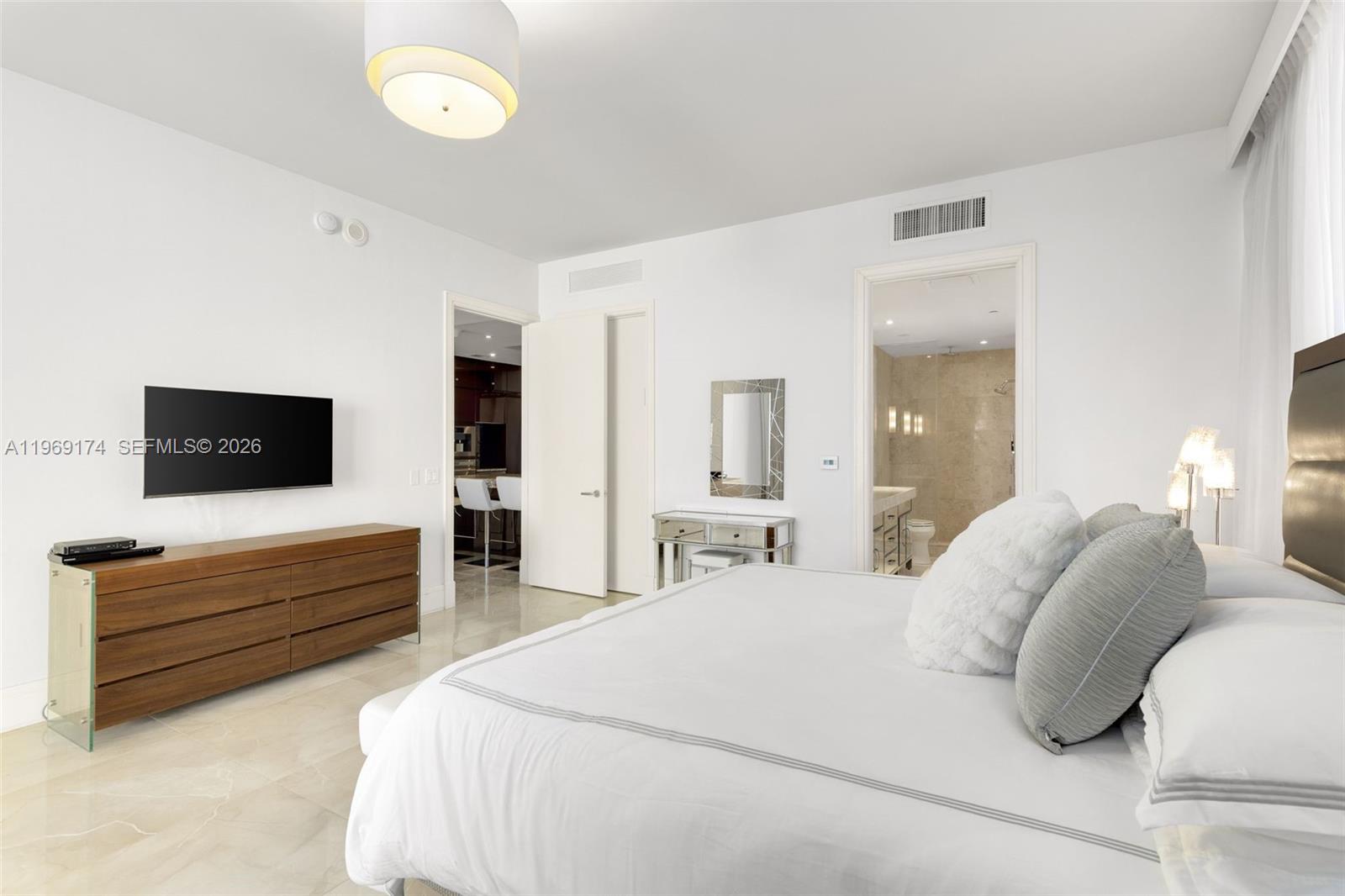 9701 Collins Avenue, Unit 404S Bal Harbour, FL 33154 - Photo 12 of 40 a bedroom with a bed and a television