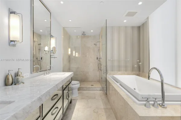 a bathroom with a tub sink and mirror