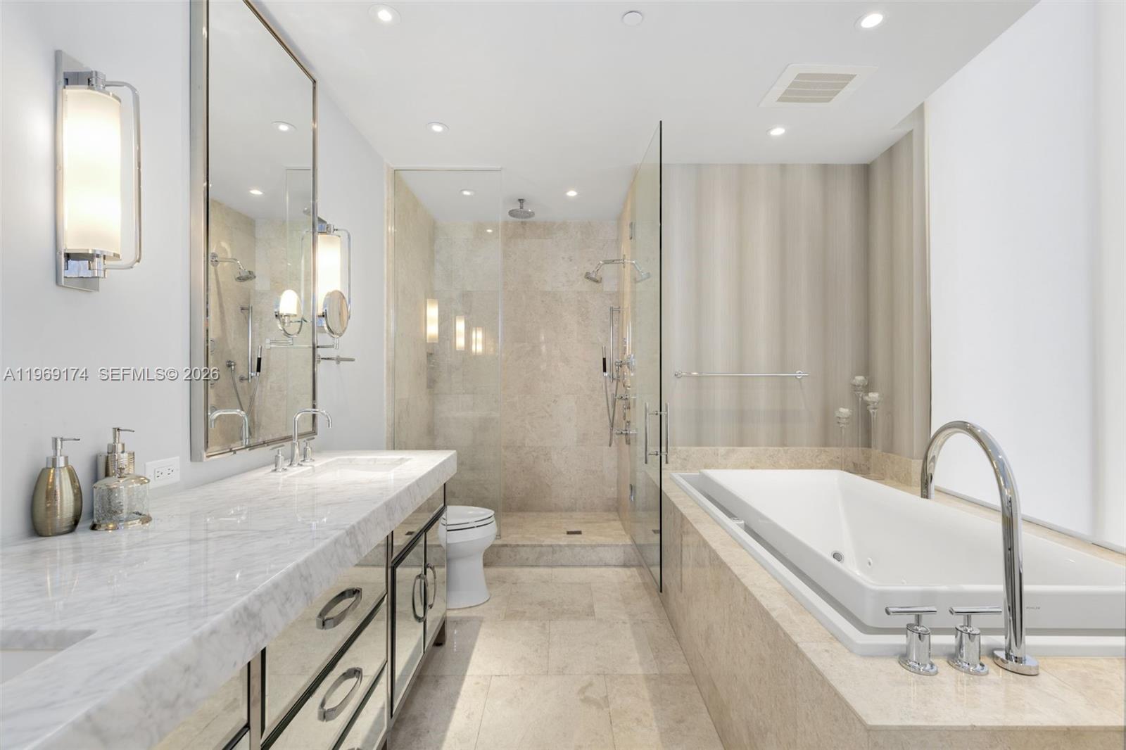 9701 Collins Avenue, Unit 404S Bal Harbour, FL 33154 - Photo 14 of 40 a bathroom with a tub sink and mirror