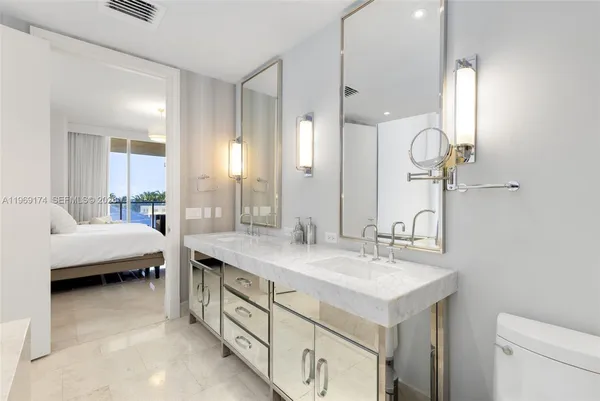 a bathroom with a sink double vanity and a mirror