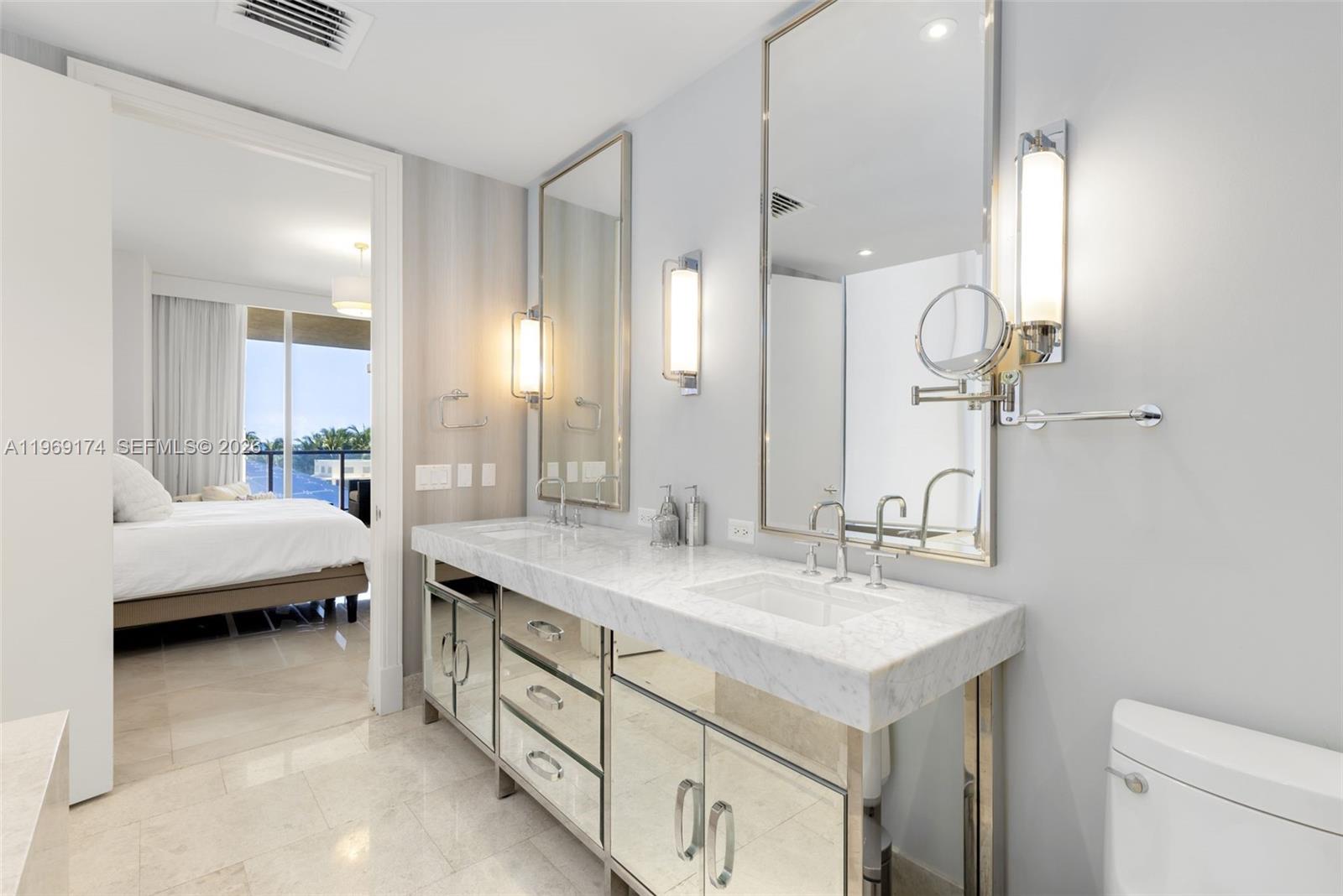 9701 Collins Avenue, Unit 404S Bal Harbour, FL 33154 - Photo 15 of 40 a bathroom with a sink double vanity and a mirror