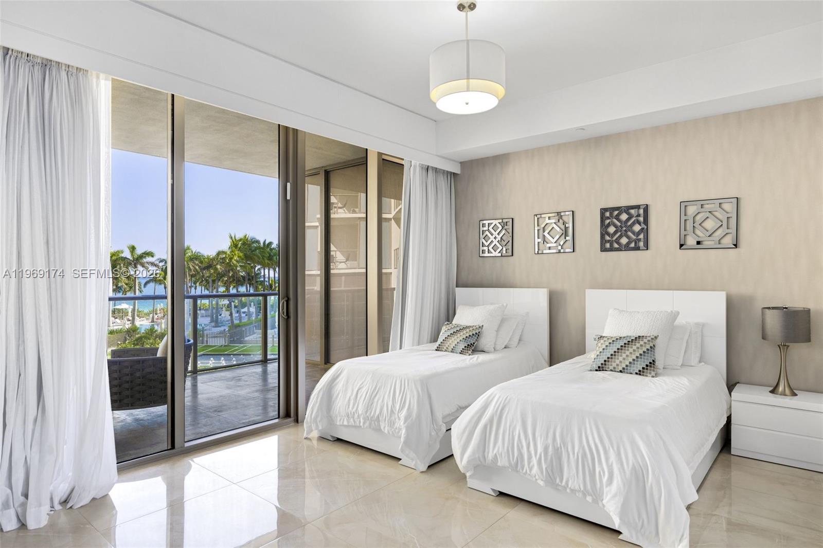9701 Collins Avenue, Unit 404S Bal Harbour, FL 33154 - Photo 16 of 40 a bedroom with two large bed and a large window