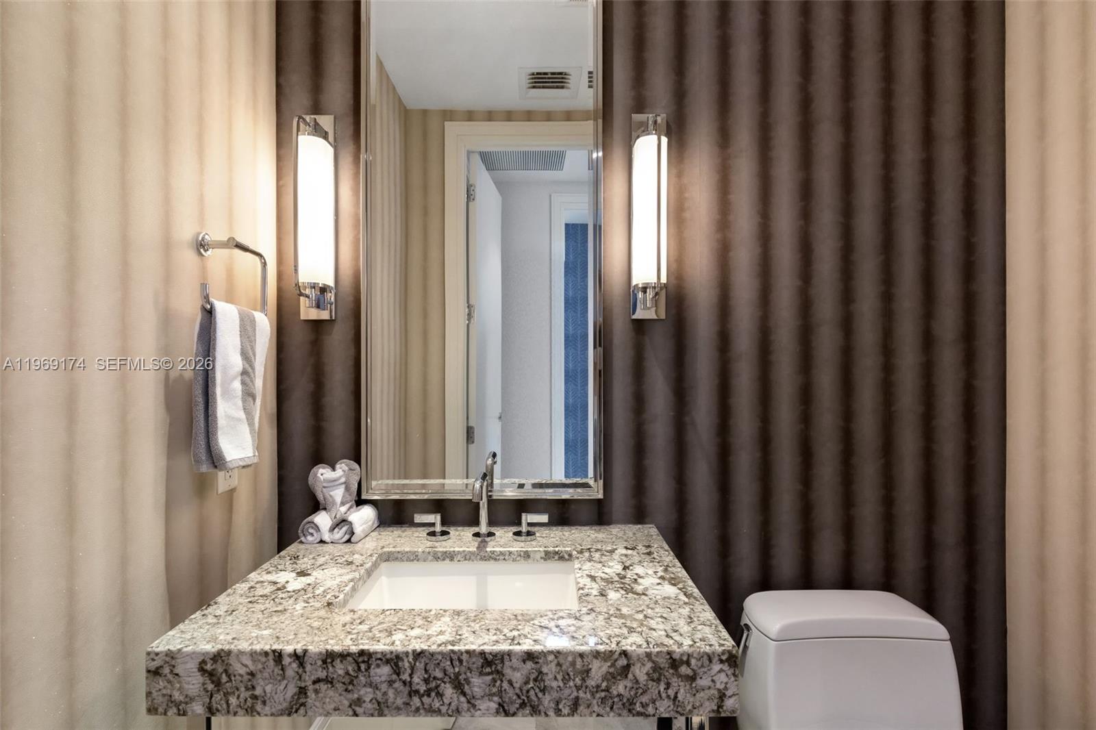 9701 Collins Avenue, Unit 404S Bal Harbour, FL 33154 - Photo 19 of 40 a bathroom with a granite countertop sink and a mirror