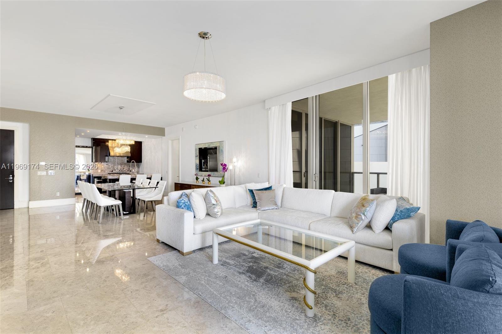9701 Collins Avenue, Unit 404S Bal Harbour, FL 33154 - Photo 2 of 40 a living room with furniture and view of kitchen