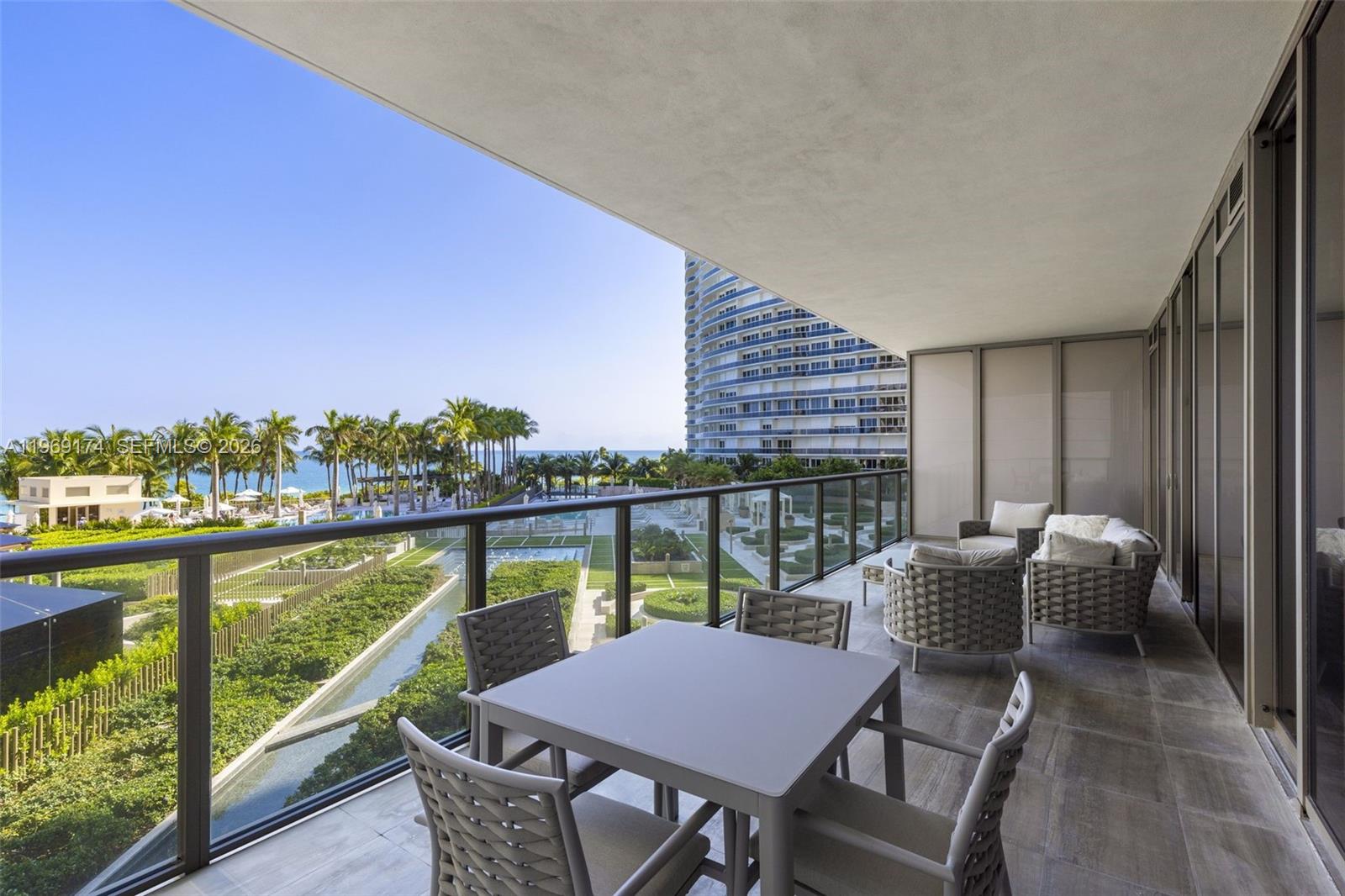 9701 Collins Avenue, Unit 404S Bal Harbour, FL 33154 - Photo 21 of 40 a balcony with an outdoor seating
