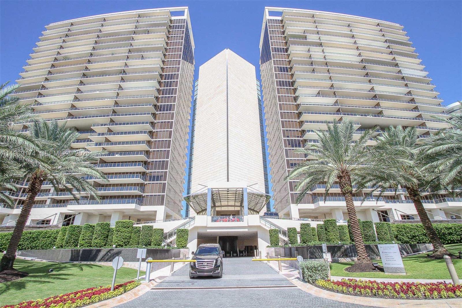 9701 Collins Avenue, Unit 404S Bal Harbour, FL 33154 - Photo 27 of 40 a front view of a building with a garden and plants