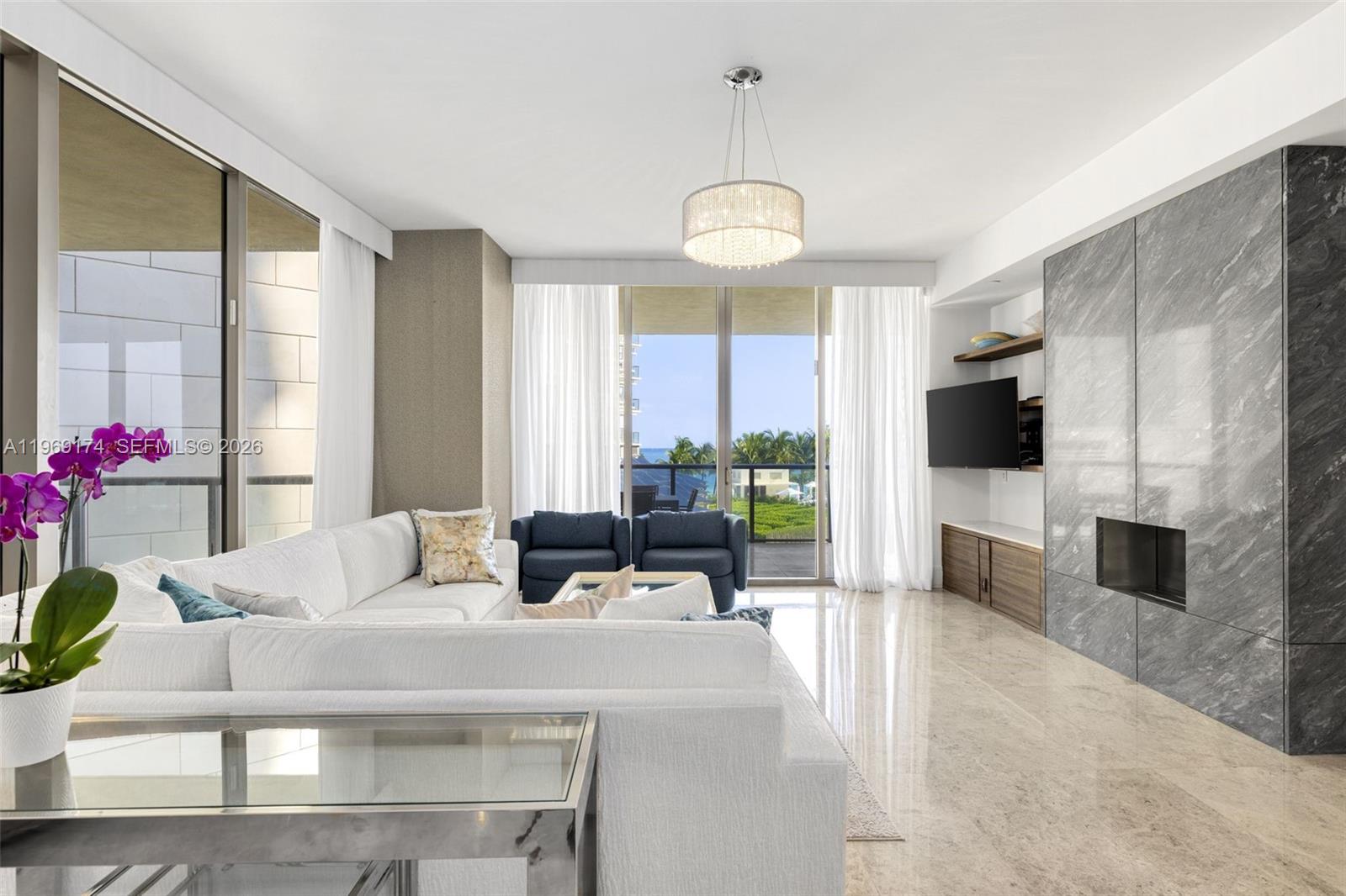 9701 Collins Avenue, Unit 404S Bal Harbour, FL 33154 - Photo 3 of 40 a living room with fireplace furniture and a flat screen tv