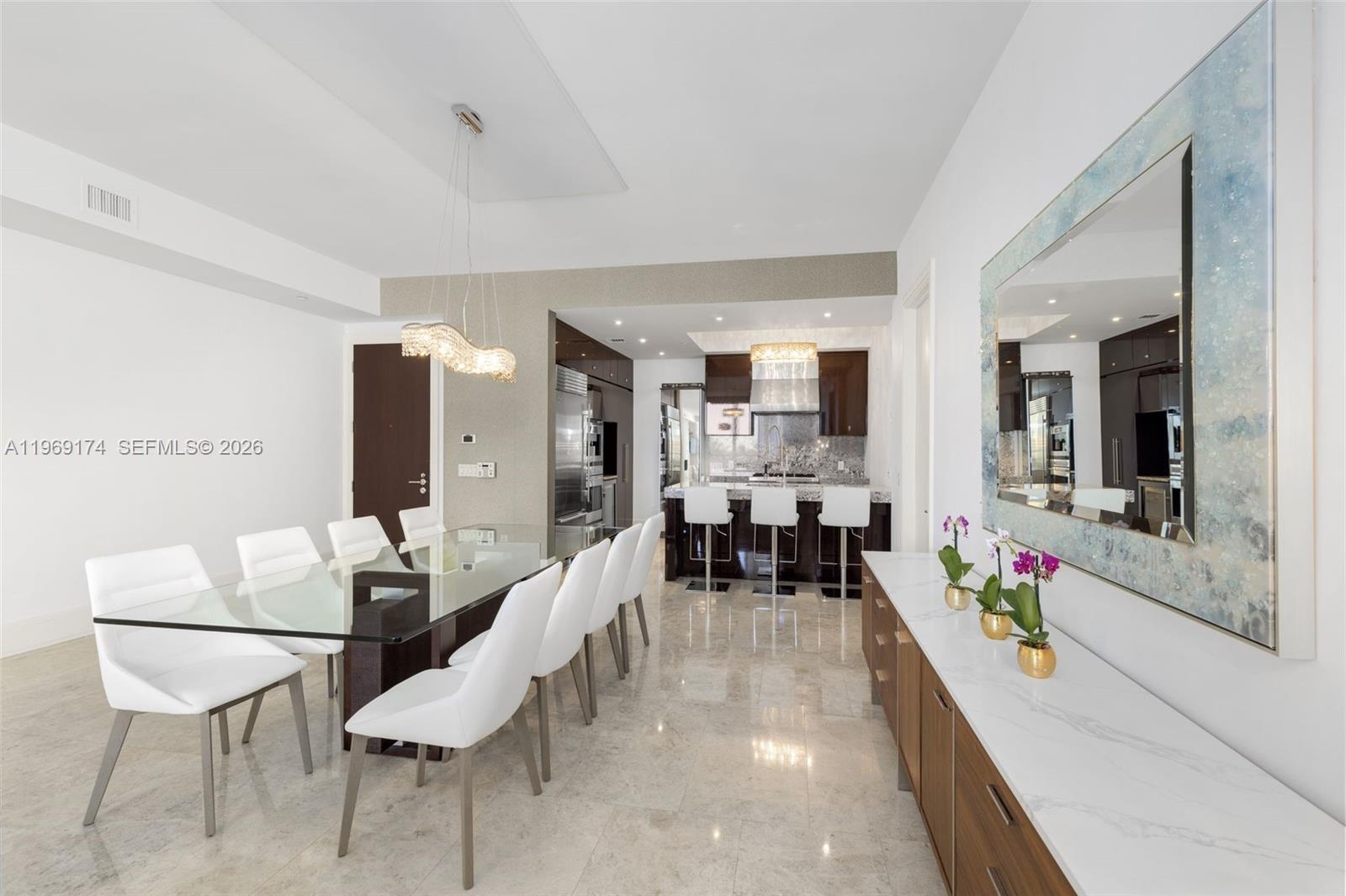 9701 Collins Avenue, Unit 404S Bal Harbour, FL 33154 - Photo 6 of 40 a living room with furniture and a large window