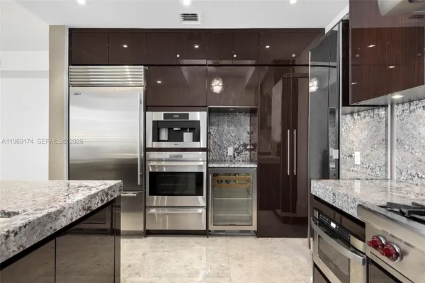 a kitchen with a refrigerator and a sink