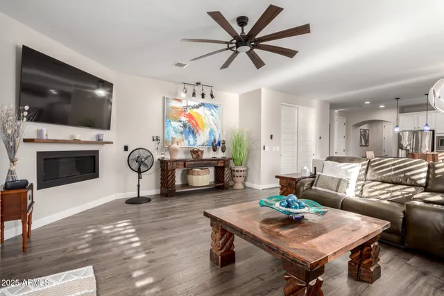 a living room with furniture a flat screen tv and a fireplace