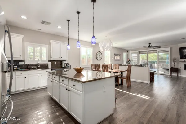a kitchen with counter space sink stove and wooden floor