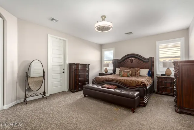 a bedroom with bed and a chandelier