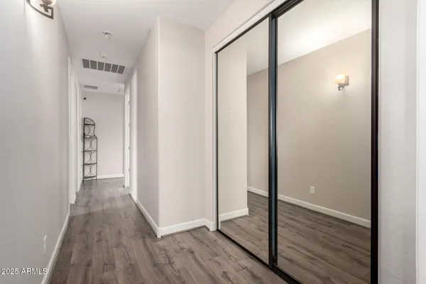 a view of hallway with wooden floor