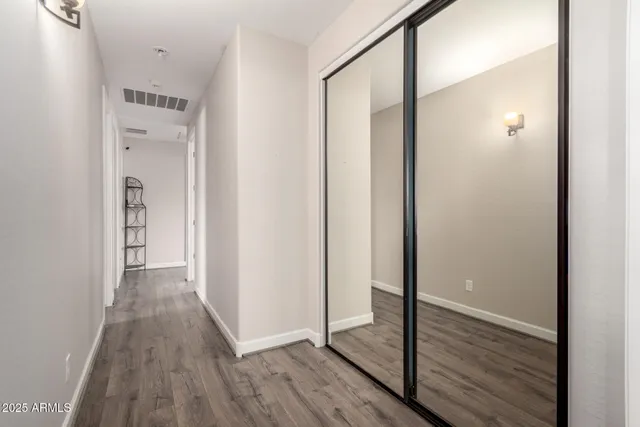 a view of hallway with wooden floor