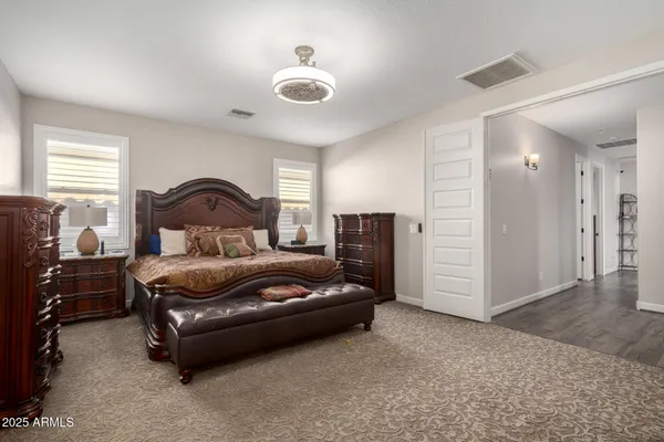 a bedroom with a bed and a chandelier