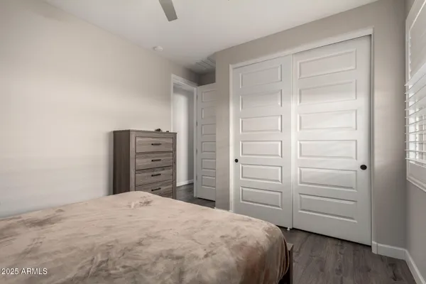 a bedroom with a bed and a mirror