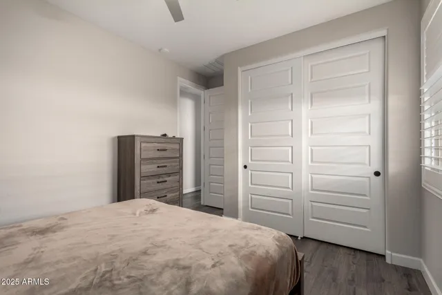 a bedroom with a bed and a mirror