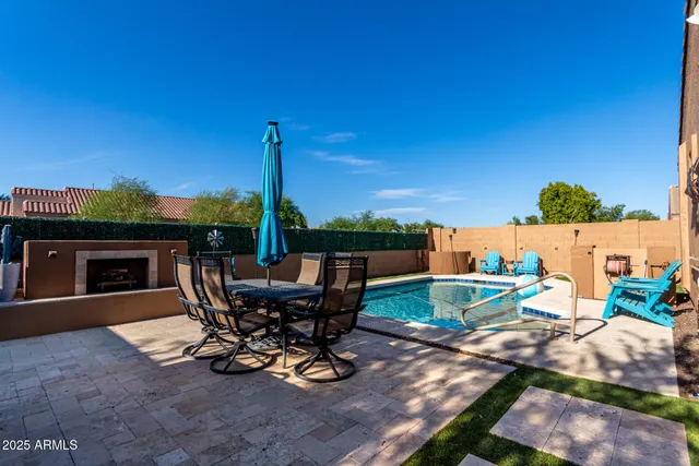 a view of a patio with table and chairs potted plants with wooden fence