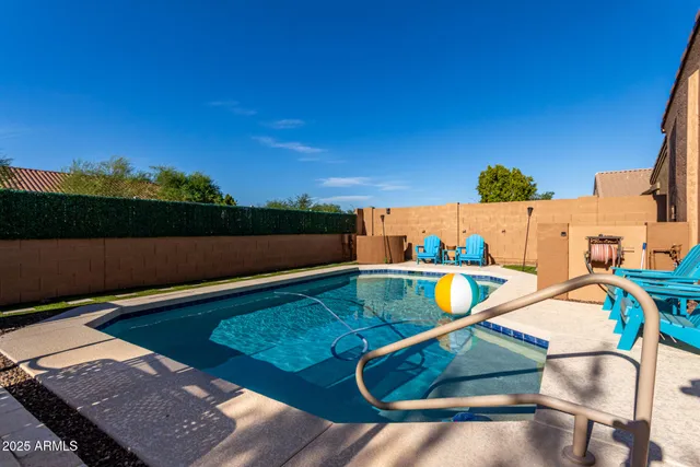 a view of house with swimming pool yard fire pit and outdoor seating