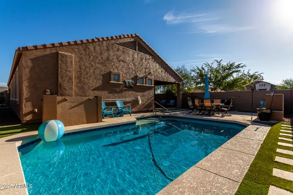 a view of roof deck with chair and potted plants