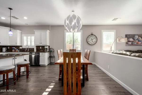 a view of a dining room with furniture window and wooden floor