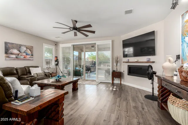 a living room with fireplace furniture and a flat screen tv