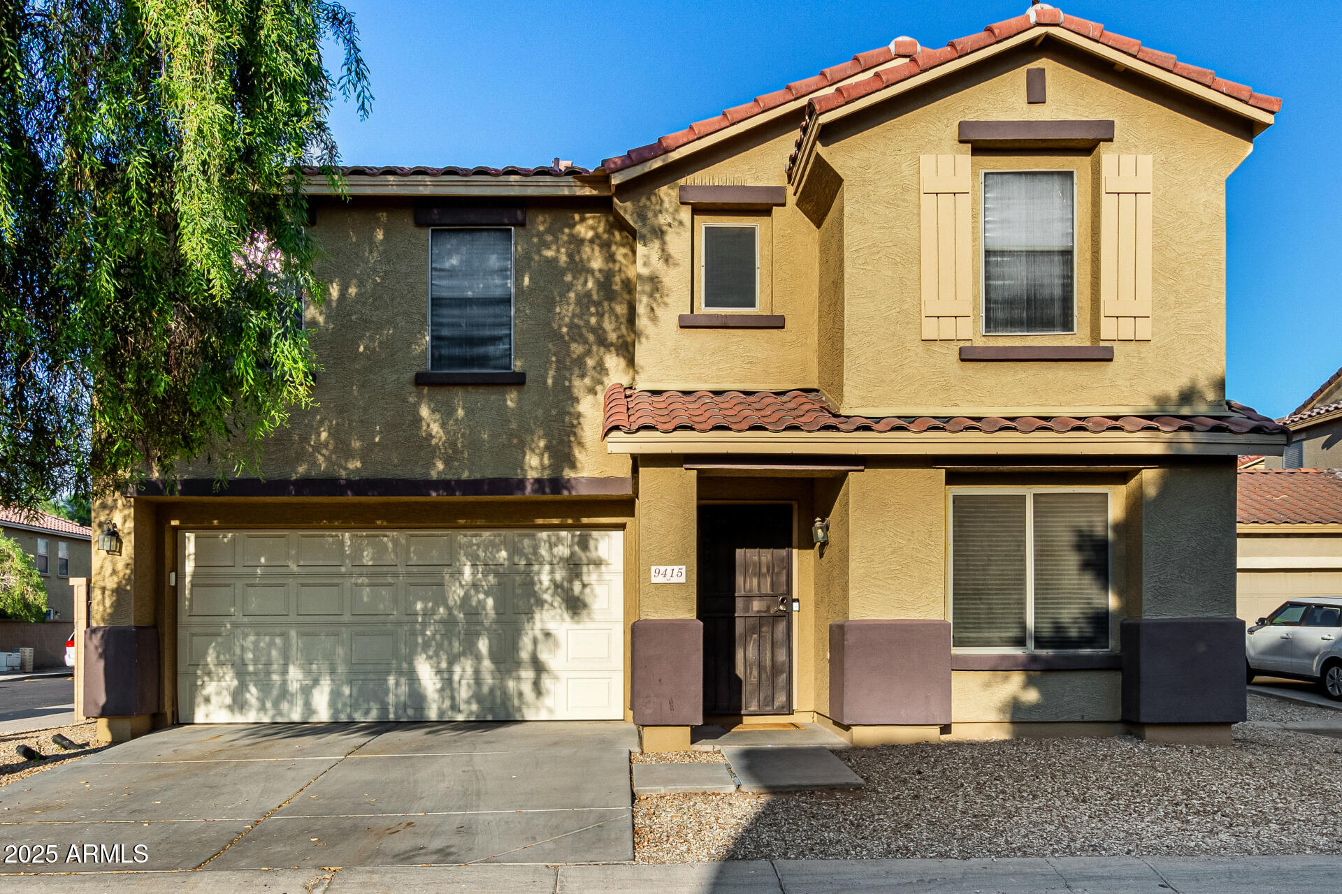 9415 West Eaton Road Phoenix, AZ 85037 - Photo 2 of 36 a front view of a house with a yard