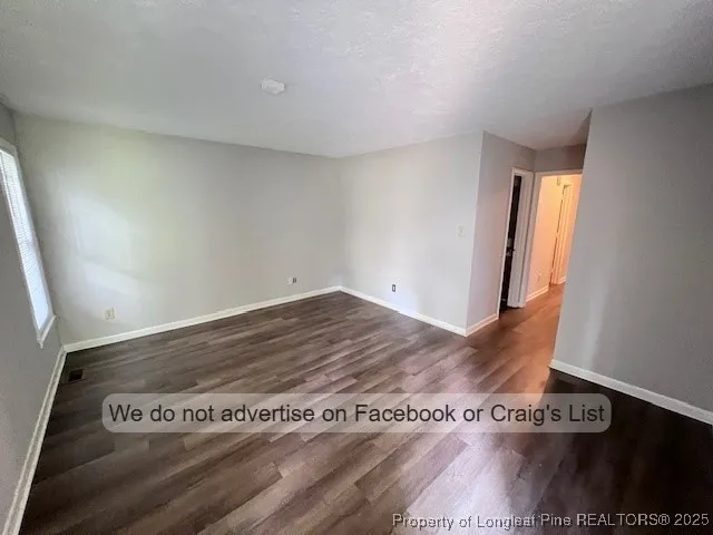a view of a room with wooden floor