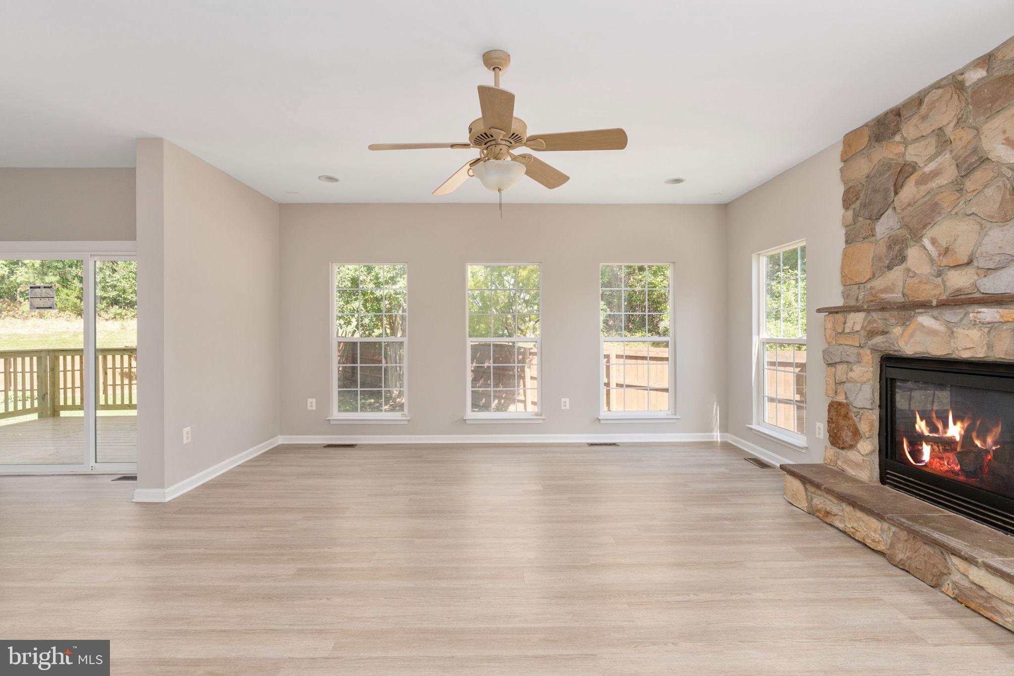 55 Hamstead Road Fredericksburg, VA 22405 - Photo 24 of 58 a view of an empty room with wooden floor fireplace and a window
