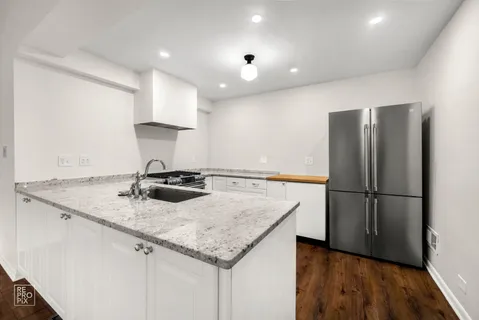 a spacious bathroom with a granite countertop sink and a large mirror
