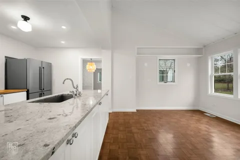 a view of kitchen with windows and refrigerator