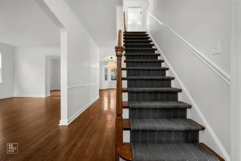 a view of entryway and hall with wooden floor