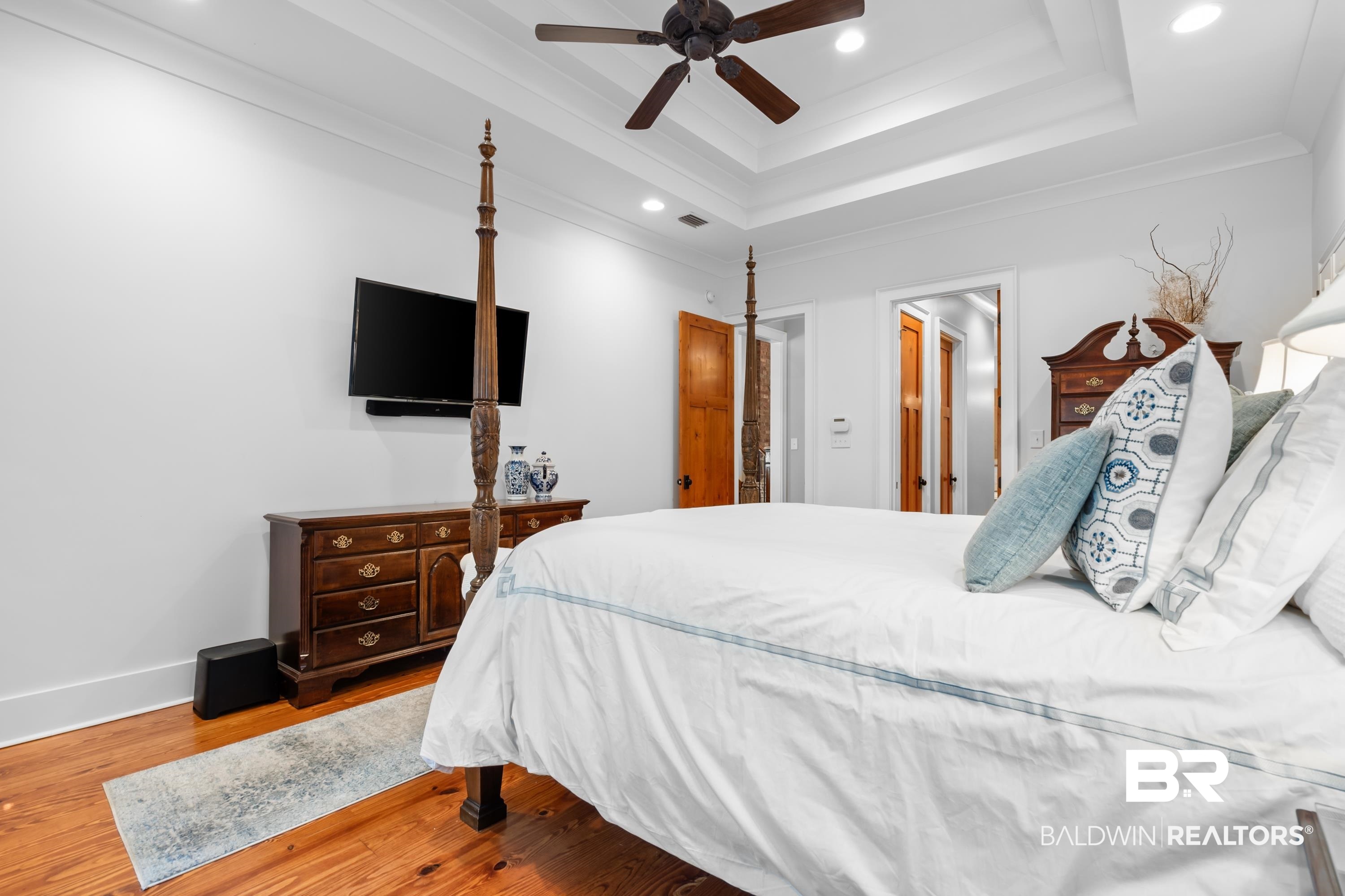 30057 Dolive Ridge Daphne, AL 36527 - Photo 20 of 55 Bedroom featuring a tray ceiling, ceiling fan, hardwood / wood-style flooring, and crown molding
