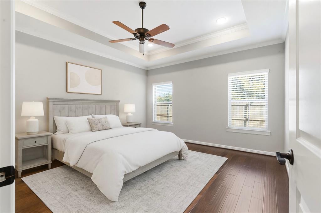 1617 Hawthorne Street Cleburne, TX 76033 - Photo 29 of 40 a bedroom with a large bed chandelier and a window
