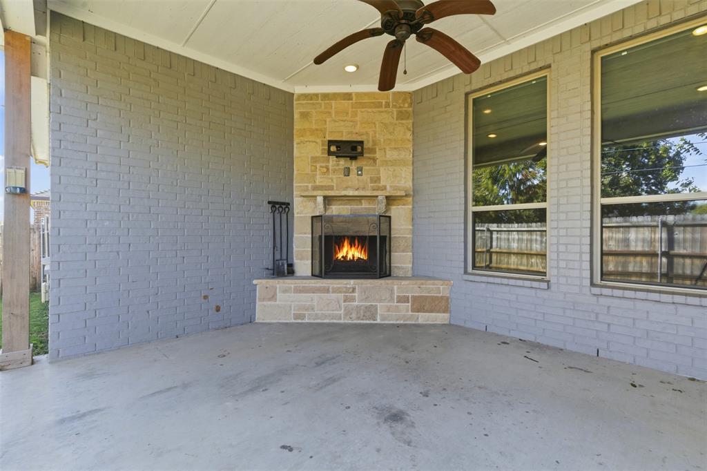 1617 Hawthorne Street Cleburne, TX 76033 - Photo 34 of 40 a view of an empty room with chandelier fan and fire place