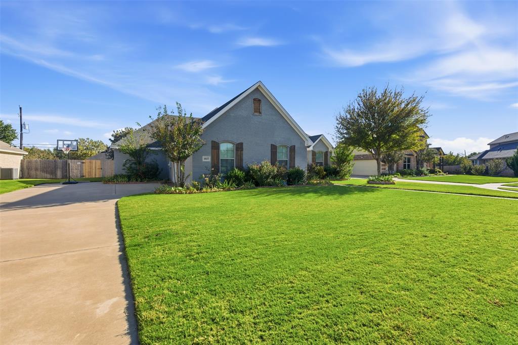 1617 Hawthorne Street Cleburne, TX 76033 - Photo 6 of 40 a view of a house with a big yard plants and large trees