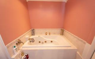 228 Clover Street Pittsburgh, PA 15210 - Photo 37 of 46 a white bath tub sitting in a bathroom