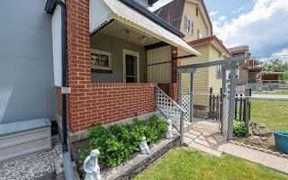 228 Clover Street Pittsburgh, PA 15210 - Photo 4 of 46 a view of a house with a small yard and wooden fence