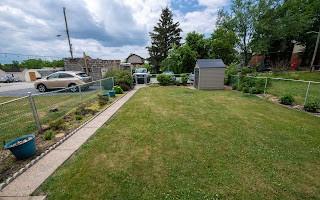 228 Clover Street Pittsburgh, PA 15210 - Photo 6 of 46 a house view with a garden