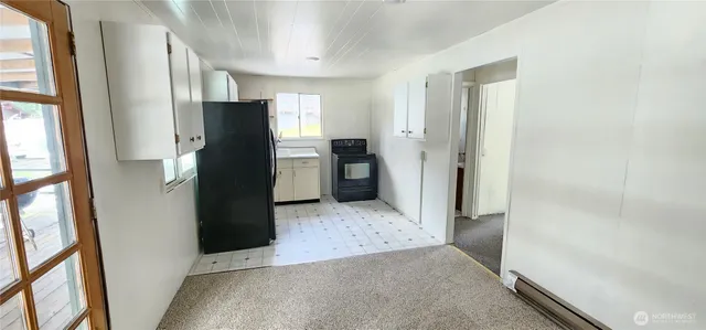 a view of a kitchen with refrigerator and cabinet
