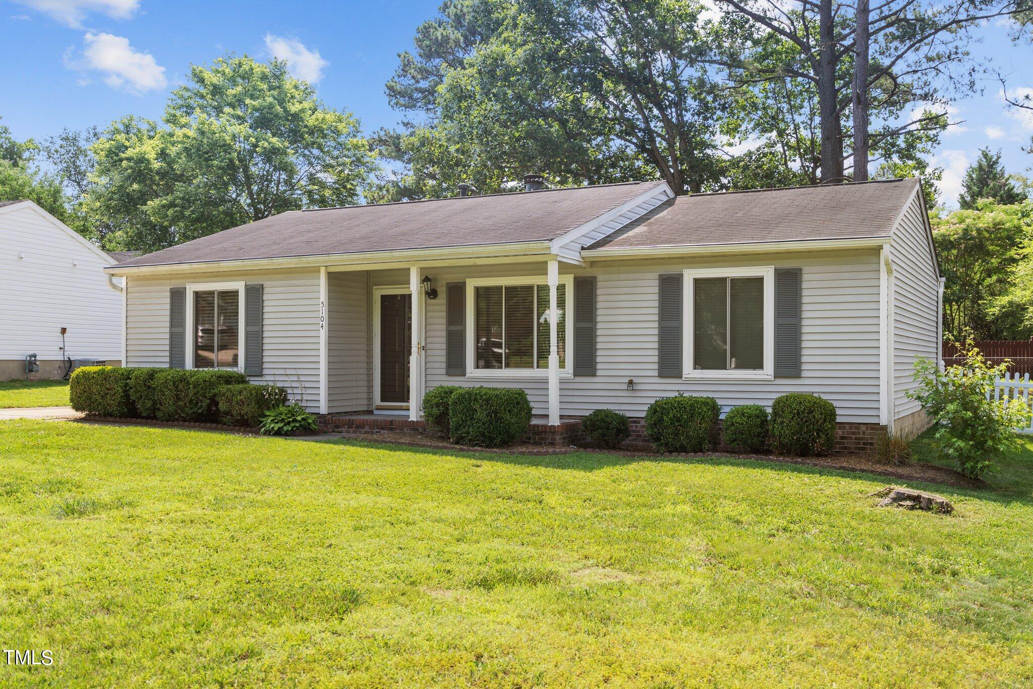 a view of a house with a yard and plants