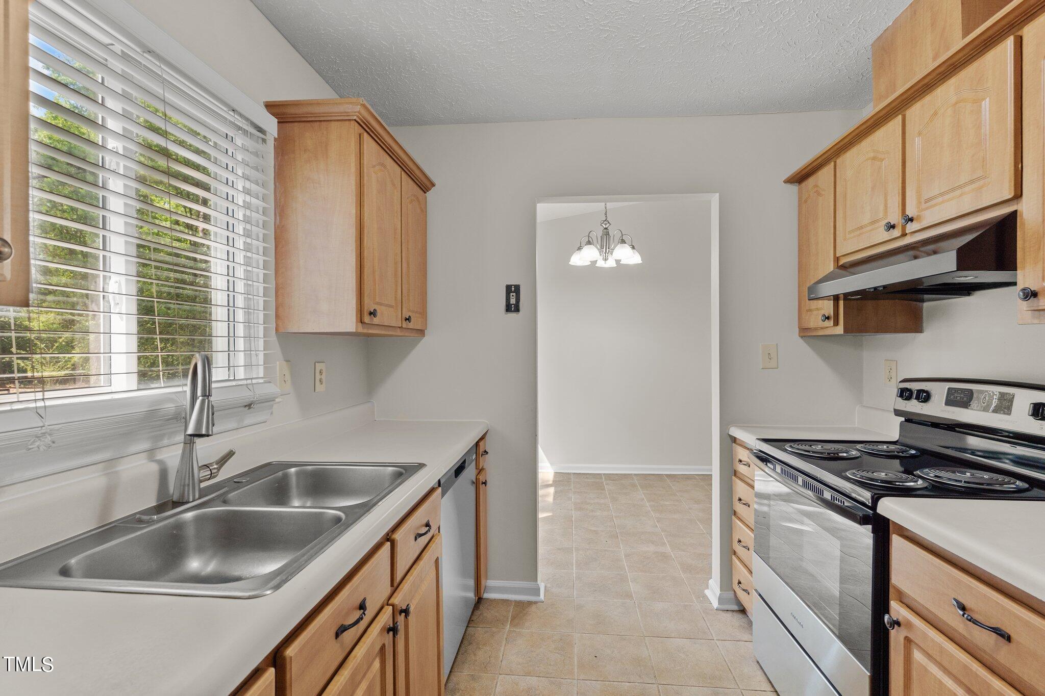 5104 Duckworth Court Raleigh, NC 27616 - Photo 12 of 36 a kitchen that has a sink and a stove