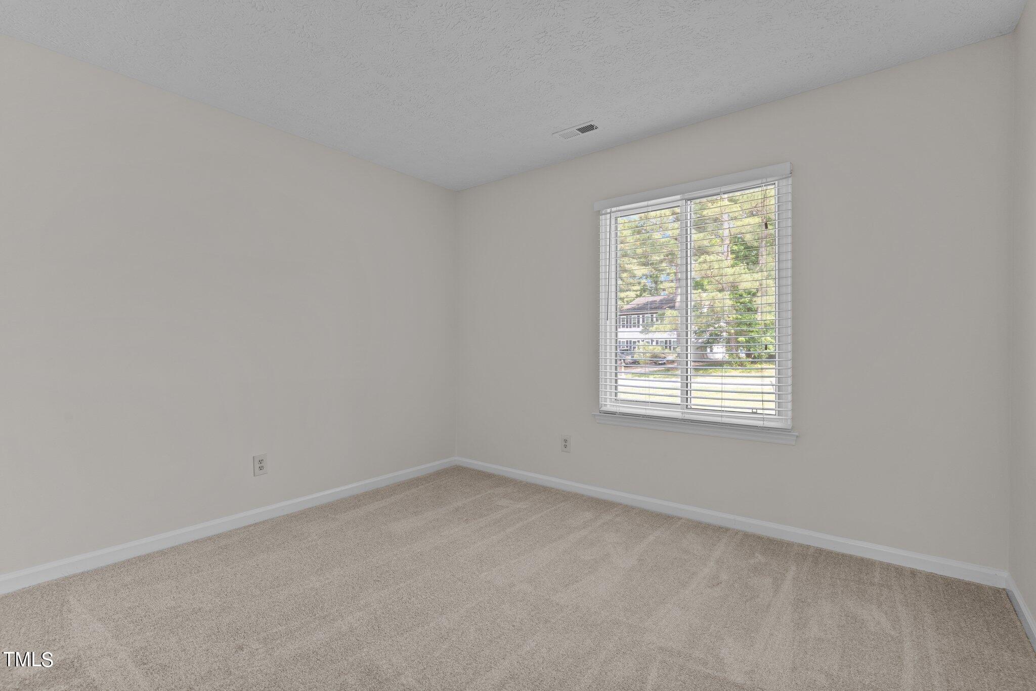 5104 Duckworth Court Raleigh, NC 27616 - Photo 13 of 36 an empty room with a window