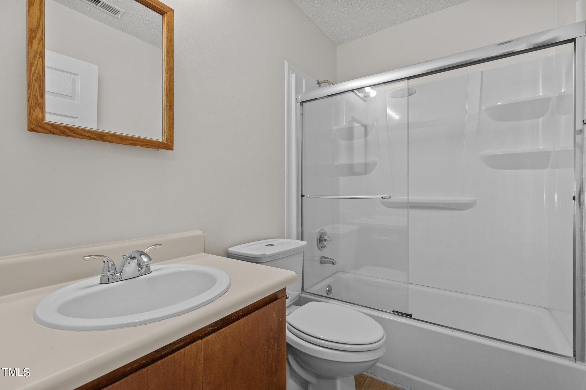 5104 Duckworth Court Raleigh, NC 27616 - Photo 16 of 36 a bathroom with a sink toilet and shower
